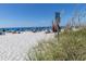 Beach with umbrellas, people relaxing, clear water at 604 Foxwood Blvd, Englewood, FL 34223