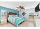 King-size bed, light blue walls, and ceiling fan at 604 Foxwood Blvd, Englewood, FL 34223