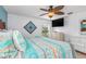 King-size bed, teal bedding, and ceiling fan at 604 Foxwood Blvd, Englewood, FL 34223