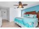 King-size bed, light blue walls, and ceiling fan at 604 Foxwood Blvd, Englewood, FL 34223