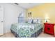 Bedroom with yellow accent wall and full-size bed at 604 Foxwood Blvd, Englewood, FL 34223