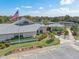 Aerial view of Foxwood community clubhouse, featuring parking and surrounding landscape at 604 Foxwood Blvd, Englewood, FL 34223