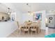 Bright dining room with light wood table and six chairs at 604 Foxwood Blvd, Englewood, FL 34223