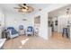 Bright sunroom with comfy wicker chairs, and view into kitchen at 604 Foxwood Blvd, Englewood, FL 34223