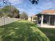 Large backyard with grassy area and privacy fence at 6379 Grand Cypress Blvd, North Port, FL 34287