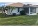 Home exterior showcasing a screened patio and grassy backyard at 6379 Grand Cypress Blvd, North Port, FL 34287