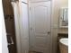 Bathroom with shower, linen closet, and door at 6379 Grand Cypress Blvd, North Port, FL 34287