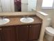 Double vanity, toilet, and granite countertop at 6379 Grand Cypress Blvd, North Port, FL 34287