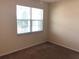 Bedroom with window and neutral walls at 6379 Grand Cypress Blvd, North Port, FL 34287