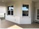 Bright front porch with tiled flooring and hurricane shutters at 6379 Grand Cypress Blvd, North Port, FL 34287