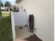 Exterior hose station with a white privacy fence at 6379 Grand Cypress Blvd, North Port, FL 34287