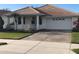 Single-story home with attached garage and manicured lawn at 6379 Grand Cypress Blvd, North Port, FL 34287