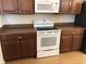 White appliances and granite countertops highlight this kitchen at 6379 Grand Cypress Blvd, North Port, FL 34287