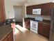 Kitchen with wood cabinets, granite countertops and a breakfast bar at 6379 Grand Cypress Blvd, North Port, FL 34287