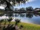 Serene lake view with lush green landscaping at 6379 Grand Cypress Blvd, North Port, FL 34287