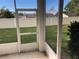 View of grassy backyard from screened patio at 6379 Grand Cypress Blvd, North Port, FL 34287