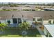 Aerial view of a residential building with parking and lush landscaping at 6796 Gasparilla Pines Blvd # 77, Englewood, FL 34224