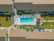 Aerial view of community pool and surrounding buildings at 6796 Gasparilla Pines Blvd # 77, Englewood, FL 34224