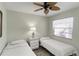 Cozy bedroom with twin beds, ceiling fan, and ample natural light at 6796 Gasparilla Pines Blvd # 77, Englewood, FL 34224