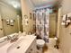 Bathroom with tub, shower, vanity, and seashell decor at 739 Tangerine Woods Blvd, Englewood, FL 34223