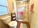 Clean bathroom with toilet, shower, and storage shelf at 739 Tangerine Woods Blvd, Englewood, FL 34223