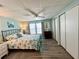 Bedroom with a queen-size bed, dresser, and ceiling fan at 739 Tangerine Woods Blvd, Englewood, FL 34223