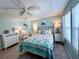 Bedroom with full-size bed, dresser, and ceiling fan at 739 Tangerine Woods Blvd, Englewood, FL 34223