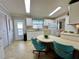 Kitchen features white cabinets, teal chairs, and a breakfast bar at 739 Tangerine Woods Blvd, Englewood, FL 34223