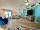 Spacious living area featuring a cozy sofa and a lovely accent wall at 739 Tangerine Woods Blvd, Englewood, FL 34223