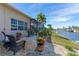 Relaxing patio area with wicker chairs, overlooking a canal at 920 Via Tripoli, Punta Gorda, FL 33950