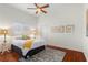 Comfortable bedroom with hardwood floors and a ceiling fan at 920 Via Tripoli, Punta Gorda, FL 33950