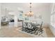 Bright dining room with glass table, chandelier, and area rug at 920 Via Tripoli, Punta Gorda, FL 33950