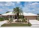 House exterior featuring a tile roof, palm tree, and stone driveway at 920 Via Tripoli, Punta Gorda, FL 33950