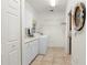 Bright laundry room with cabinets, washer, dryer, and storage at 920 Via Tripoli, Punta Gorda, FL 33950