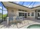 Outdoor kitchen with bar seating and adjacent spa at 920 Via Tripoli, Punta Gorda, FL 33950