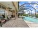 Resort-style pool and spa with screened enclosure, overlooking canal at 920 Via Tripoli, Punta Gorda, FL 33950