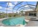 Relaxing pool and spa area with a screened enclosure and water views at 920 Via Tripoli, Punta Gorda, FL 33950