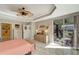 Main bedroom with coral bedding, sliding doors to a balcony and a view at 1000 San Lino Cir # 1011, Venice, FL 34292