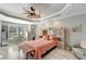 Main bedroom with coral bedding, ceiling fan, and built-in dresser at 1000 San Lino Cir # 1011, Venice, FL 34292