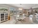 Elegant dining area with glass table and white leather chairs at 1000 San Lino Cir # 1011, Venice, FL 34292