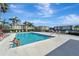 Community pool with surrounding lounge chairs at 1000 San Lino Cir # 1011, Venice, FL 34292