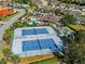 Aerial view of the Oak Forest community amenities featuring tennis courts, a pool, and a bocce ball court at 1117 Topelis Dr, Englewood, FL 34223