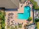 Aerial view of the community pool with plenty of lounge seating and lush landscaping at 1117 Topelis Dr, Englewood, FL 34223