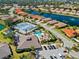 Aerial view of Oak Forest amenities including a pool, clubhouse, tennis courts and lush landscaping at 1117 Topelis Dr, Englewood, FL 34223