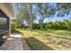 Lush backyard features a well-maintained lawn with large, mature trees, offering plenty of shade and privacy at 1117 Topelis Dr, Englewood, FL 34223