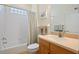 Bright bathroom with a shower and tub combination, complemented by a neutral-toned vanity and mirror at 1117 Topelis Dr, Englewood, FL 34223