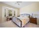 Cozy bedroom with a decorative bed, bay window, and neutral carpeting at 1117 Topelis Dr, Englewood, FL 34223