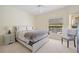 Neutral bedroom featuring a queen bed, side tables, and soft carpet at 1117 Topelis Dr, Englewood, FL 34223