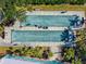 Aerial view of bocce ball courts with players enjoying the beautiful weather in Oak Forest Community at 1117 Topelis Dr, Englewood, FL 34223