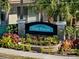 Oak Forest community entrance sign surrounded by lush landscaping and mature palm trees at 1117 Topelis Dr, Englewood, FL 34223